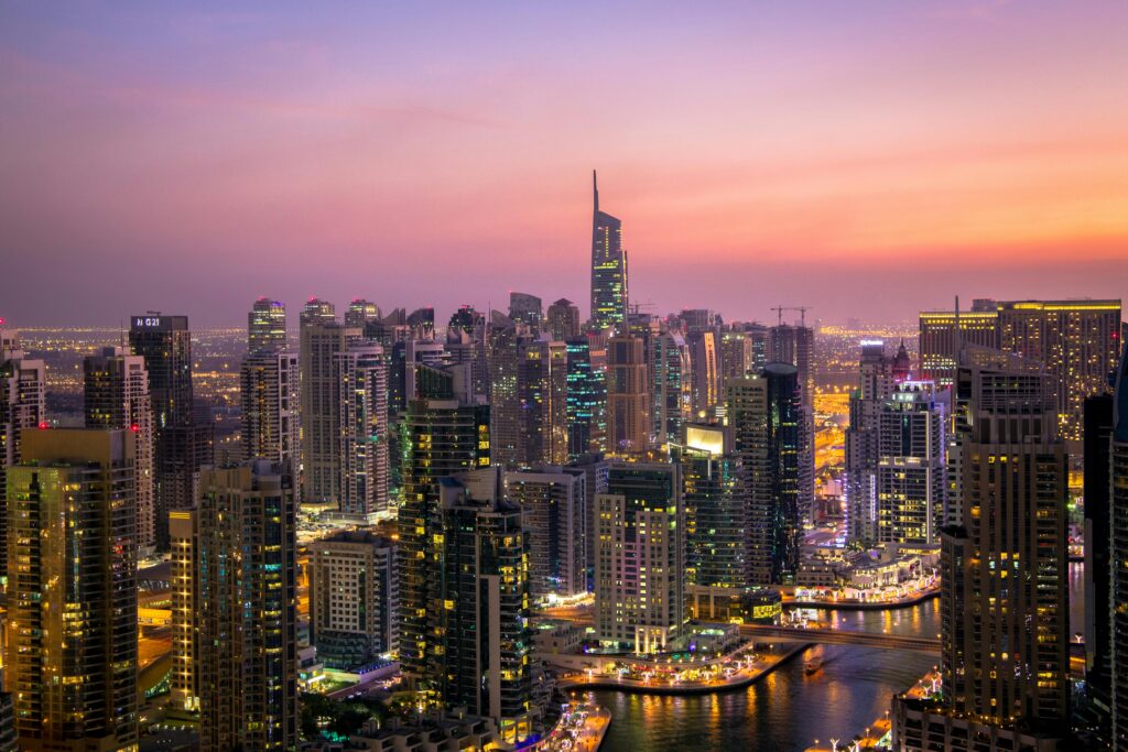 Captivating view of Dubai's skyline at dusk with vibrant city lights and skyscrapers.